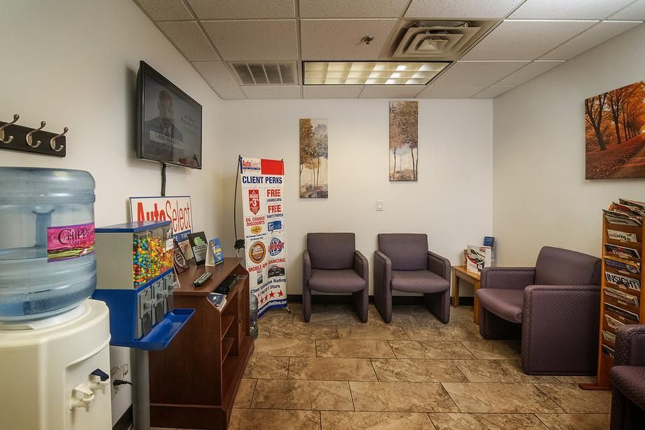 A waiting room with chairs and a water cooler