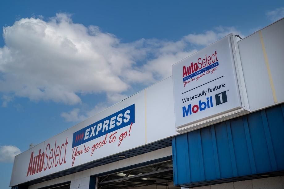 A white and blue building with a sign that says autoselect express.