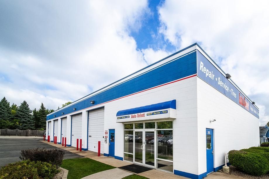 A white and blue building with a lot of windows and doors.