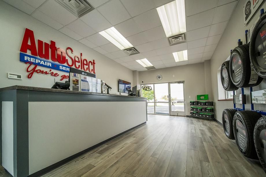 A large room with a counter and tires on display.