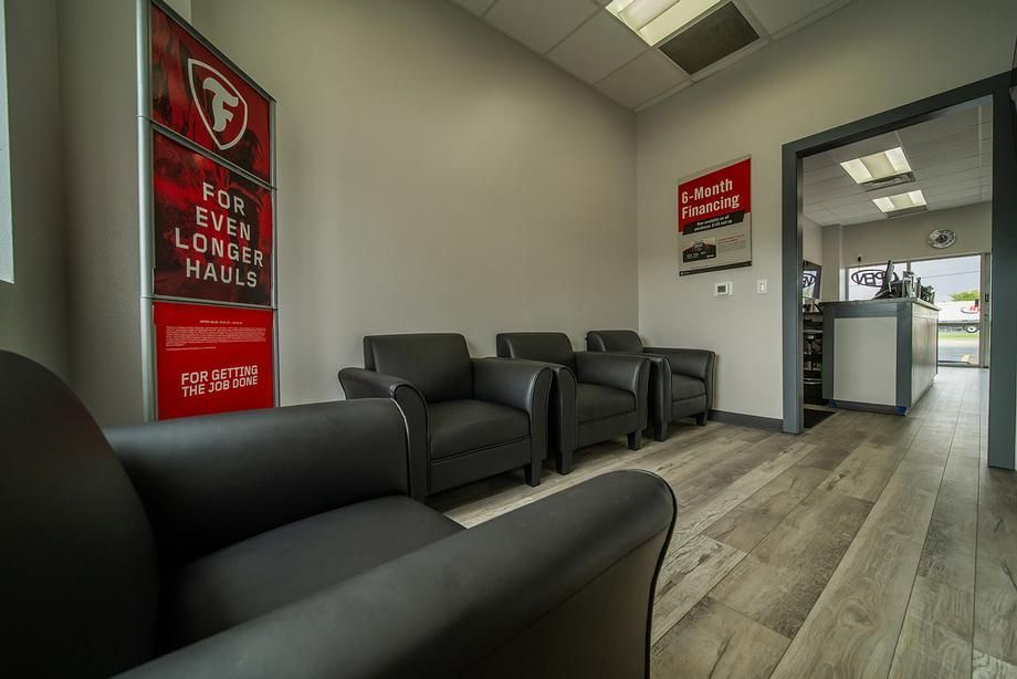 A waiting room with chairs and a sign that says `` for ever longer hauls ''.