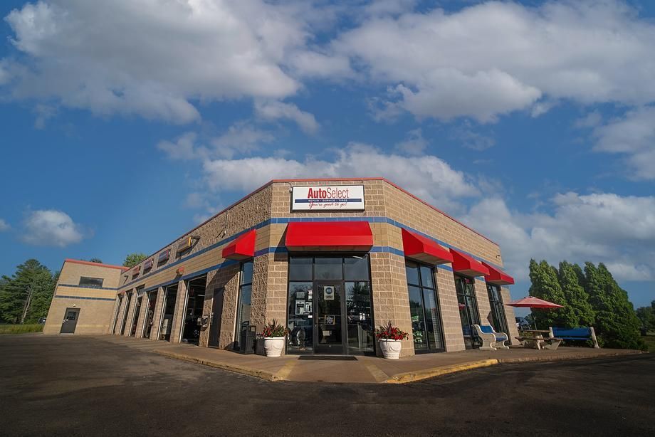 A large brick building with red awnings on the side of it.