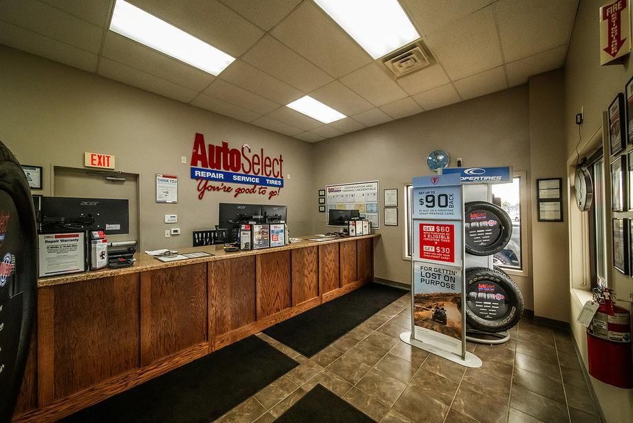 A large room with a counter and a display of tires.