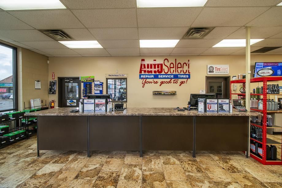 The inside of a car parts store with a long counter.