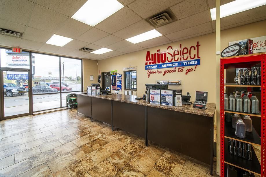 The inside of an auto select tire store with a red refrigerator.
