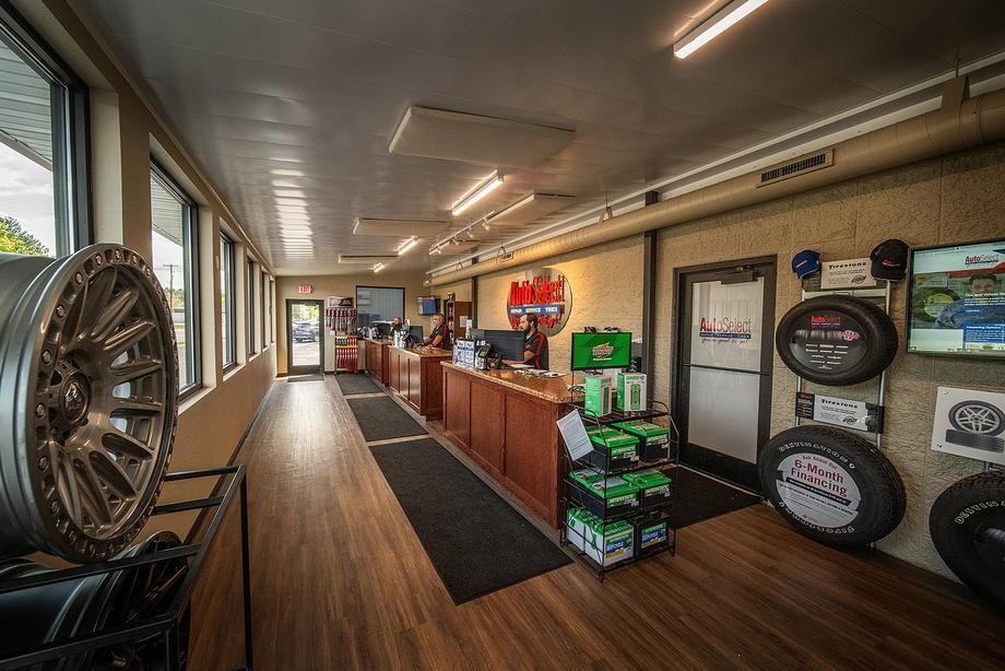 A large room with a lot of windows and tires on the wall.
