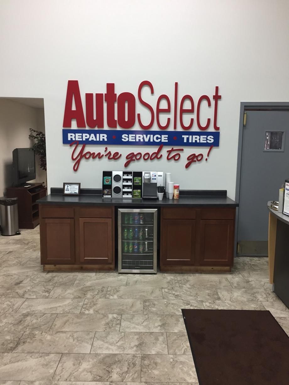 There is a sign on the wall that says `` autoselect repair service tires you 're good to go ''.