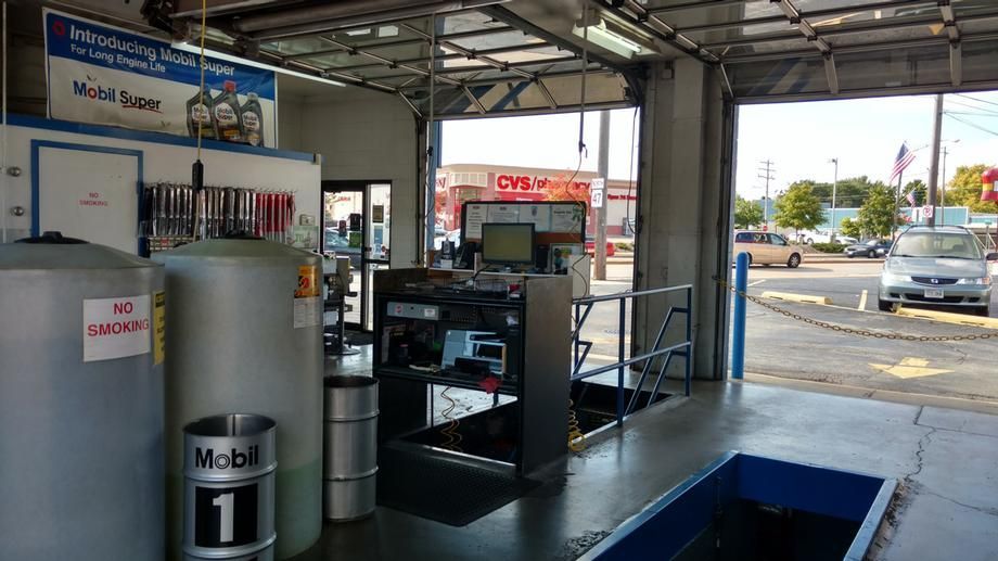 The inside of a car wash with a car parked in the background.
