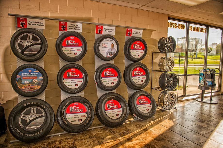 A display of tires and wheels in a tire store.