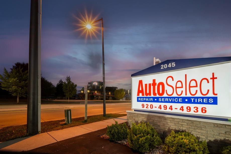 A sign for autoselect is lit up at night.