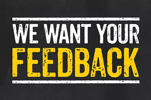 A sign that says we want your feedback on a black background