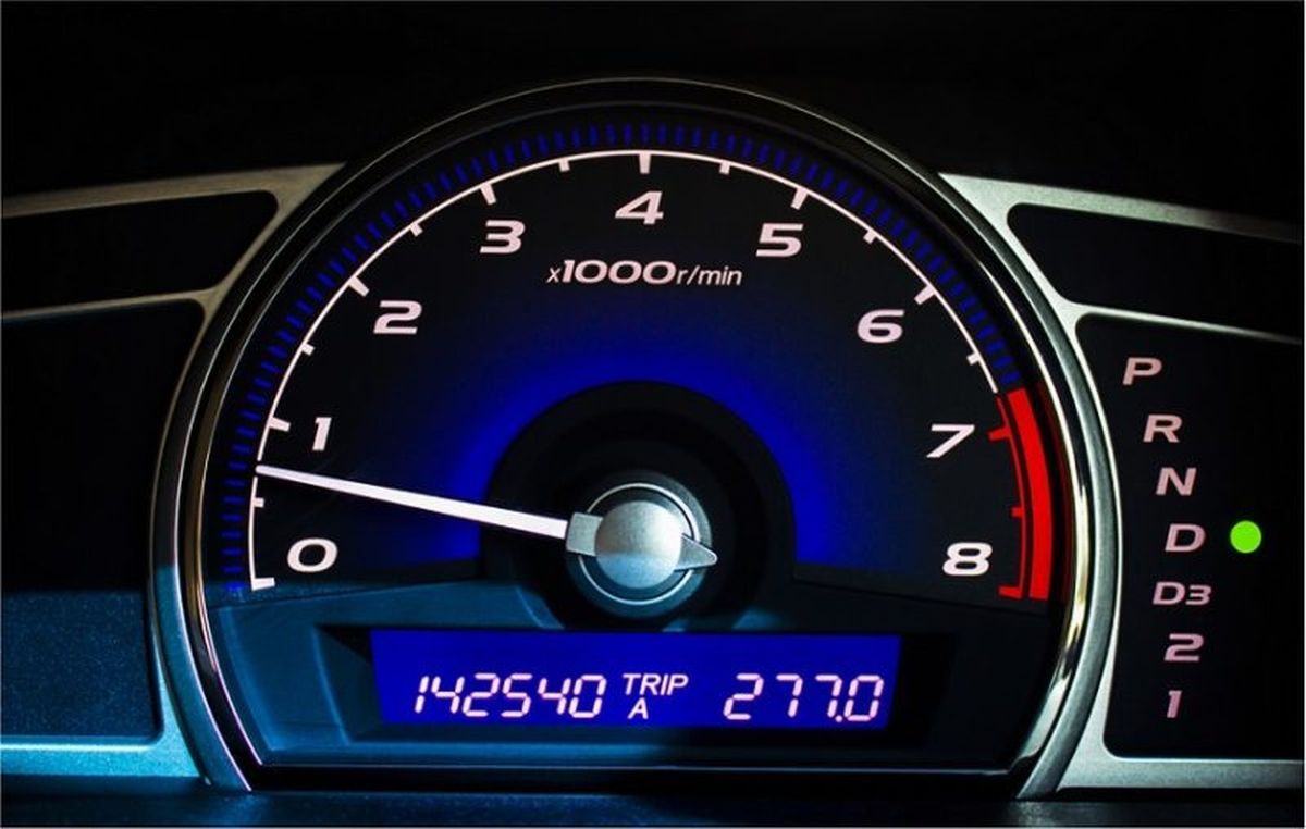 A close up of a speedometer that reads 142540 rpm