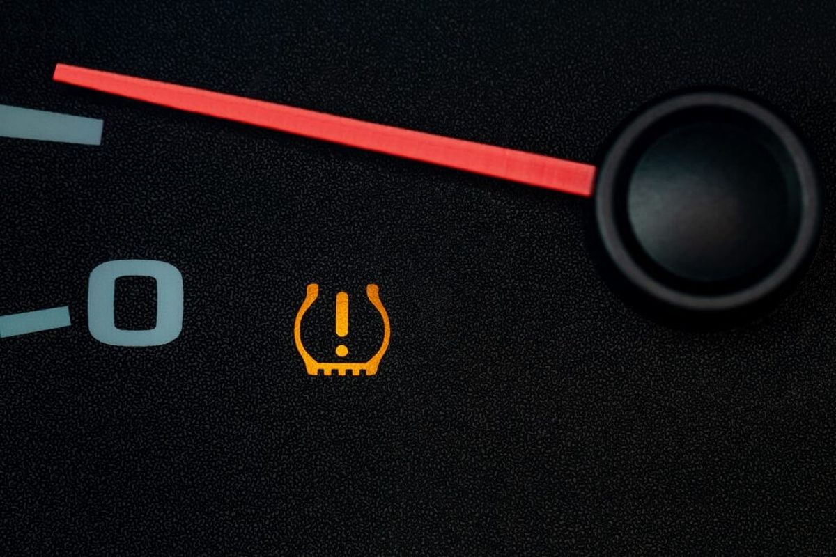 A close up of a tire pressure gauge on a car dashboard.