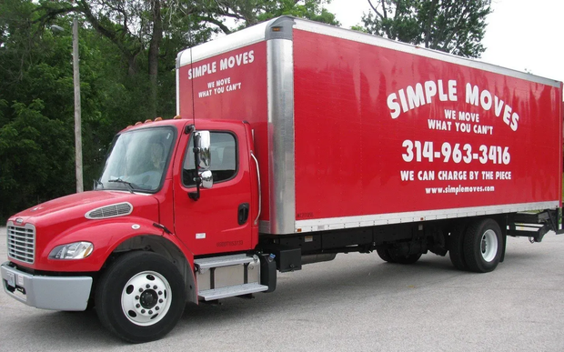 Simple Moves team stands in front of moving storage boxes