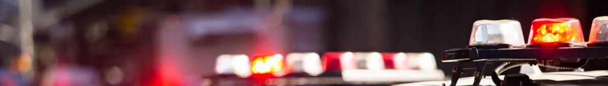 Emergency vehicle with flashing lights in a dark setting, indicating an accident or incident.