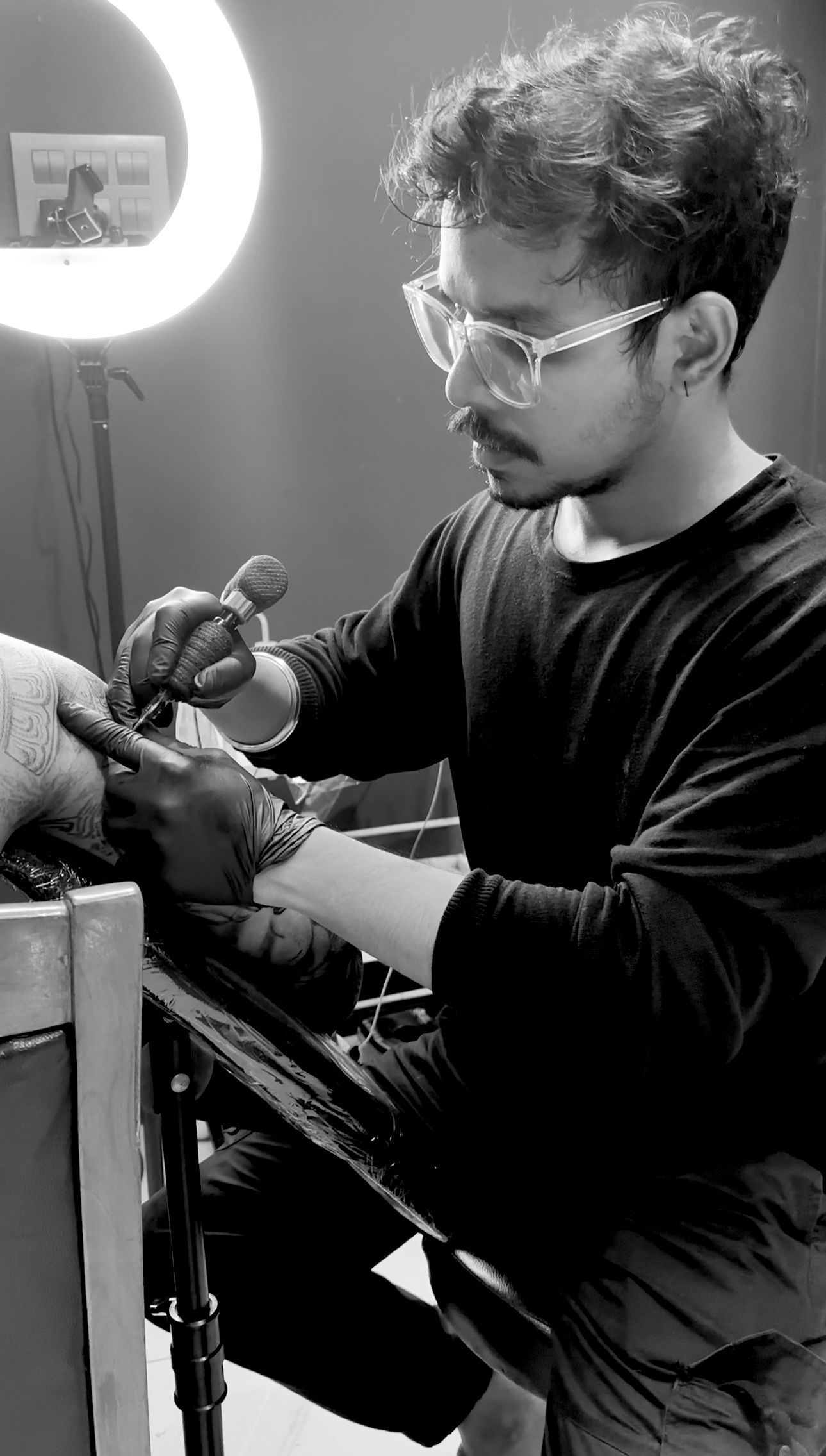 Praveen tattooing someone