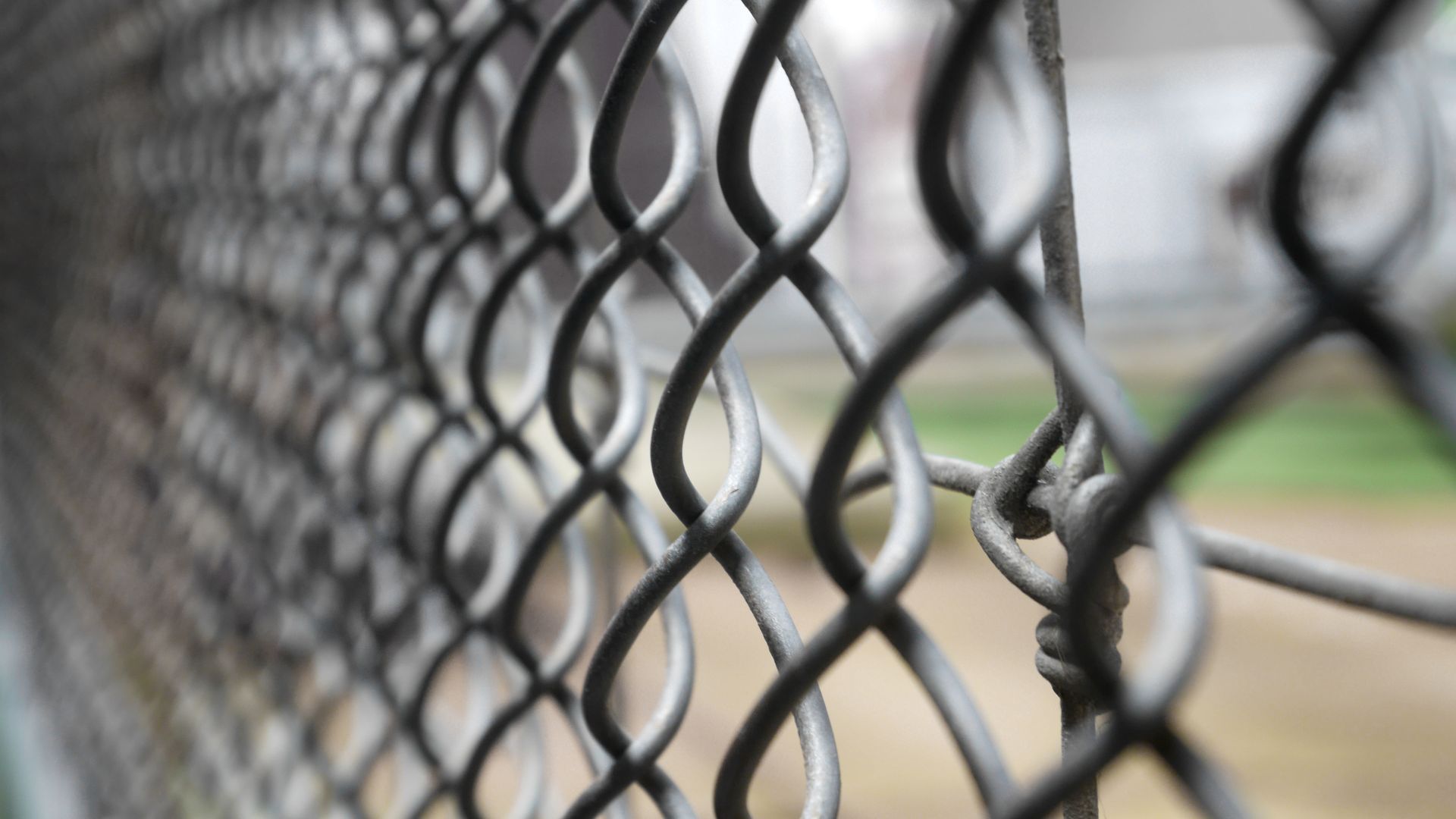 Close-up of a steel chain-link fence, installed by a commercial fence contractor.