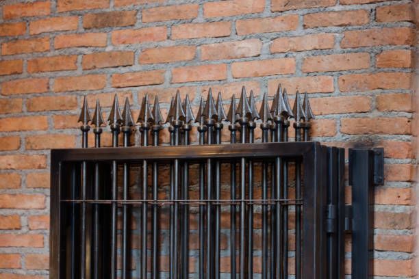 Aluminum fence in private area, showcasing secure design by a trusted commercial fence contractor.