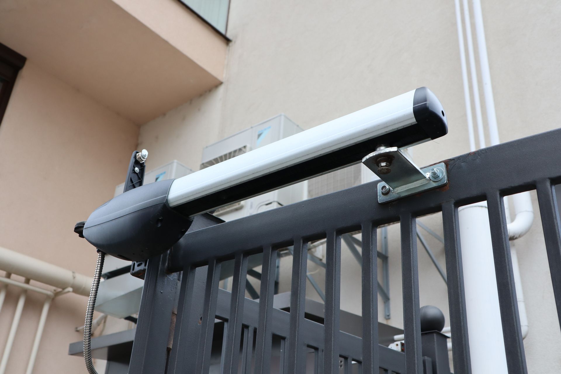 A modern, sleek automated gate operator installed to enhance security in residential areas.