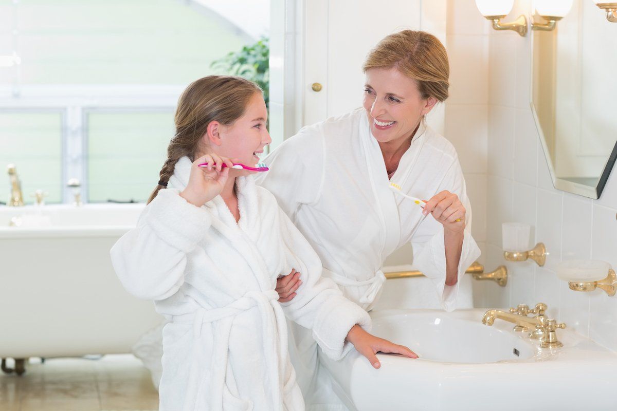 Mom And Daughter Brushing Teeth — Melbourne, VIC — DonEast Dental