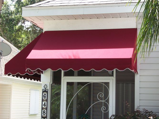 Red awning over a white framed doorway; scalloped edge.