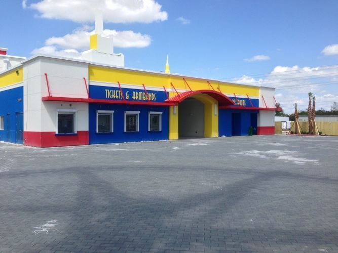A colorful building with blue, yellow, and red accents. Reads