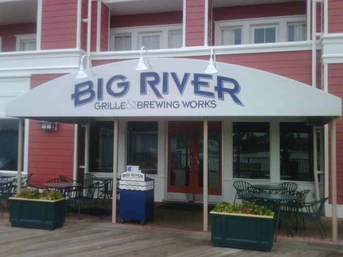 Big River Grille & Brewing Works restaurant with a red exterior and outdoor seating.