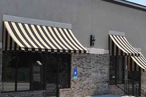 Striped awnings over shop windows.