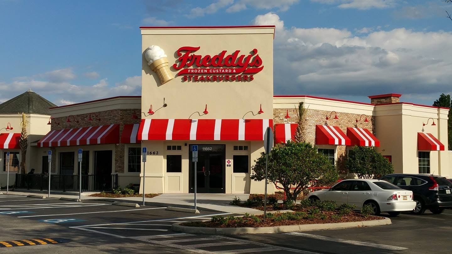 Freddie's Steakburgers restaurant with red and white awnings and a large ice cream cone sign.