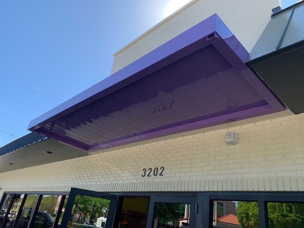 Purple awning over a building entrance with the number 3202 above the door.