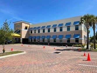 Modern metal awnings installed on a commercial building exterior. Modern metal awnings installed on a commercial building exterior.
