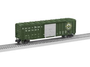 Green boxcar on railroad track with white lettering and circular logo