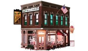 Miniature billiards club storefront model with dark red brick, neon signs, and a hanging American flag.