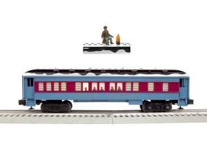 Blue and maroon model train car on a track with a small figure above it