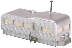 Silver retro camper trailer with striped windows and a small chimney
