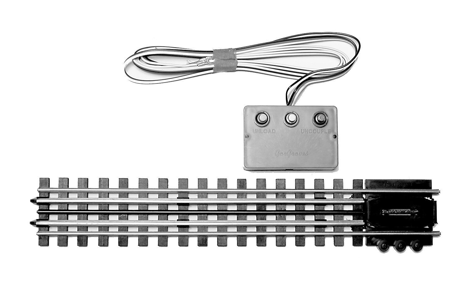 Toy model train track with wired controller and coiled cable on a white background