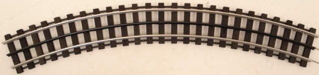 Curved section of model train track on a light background