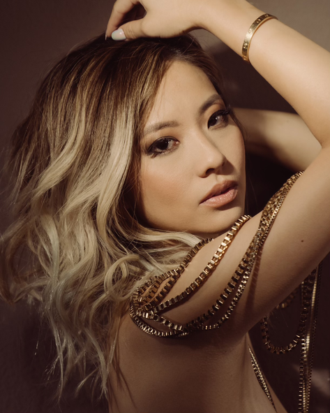 A close up of a woman 's face with a necklace around her neck