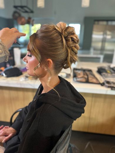 A woman is getting her hair done in a salon.