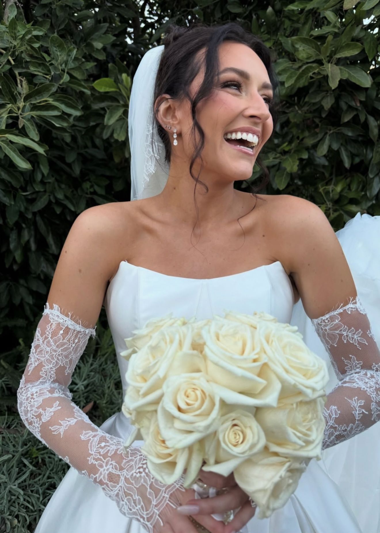 A bride and her bridesmaids are posing for a picture in a field.