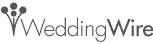 A logo for wedding wire with a flower in the middle.