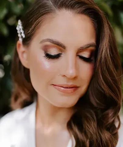 A close up of a woman wearing makeup and a hair clip.