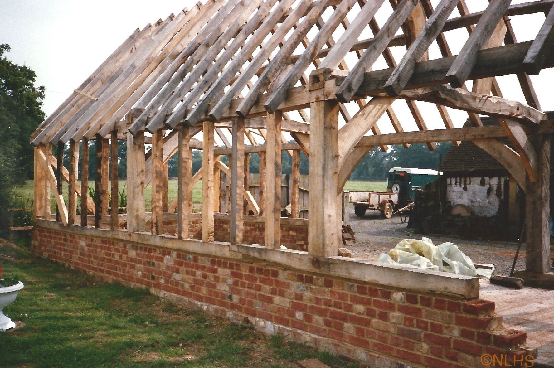A wooden structure with a brick wall in front of it