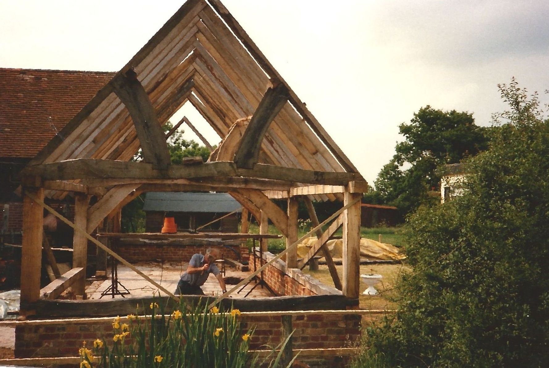 A wooden structure is being built in a field