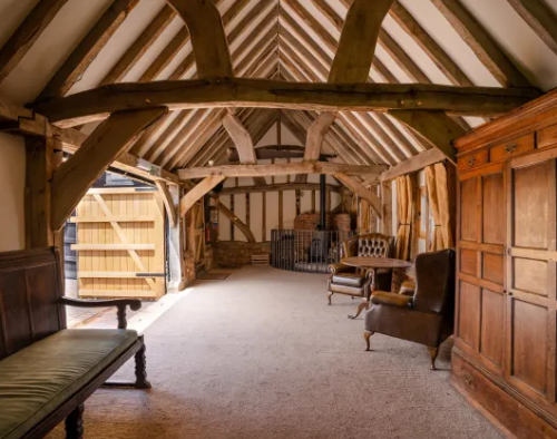A large room with wooden furniture and a wooden ceiling