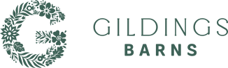 The logo for gildings barns has a floral wreath around the letter g.