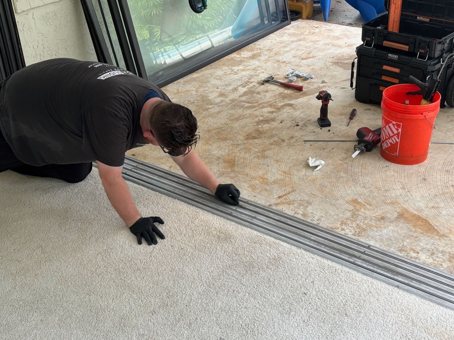 Florida sliding glass door repair technician repairing a sliding glass door track