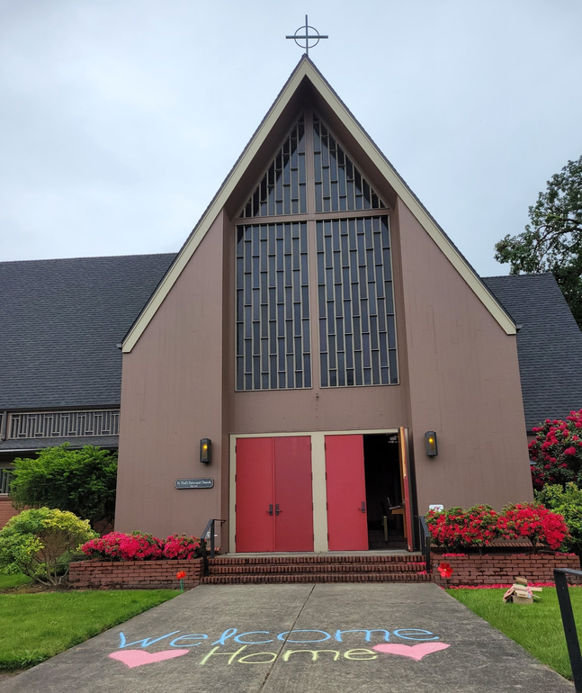 St. Paul's church on a cloudy day, as viewed from Meyer's Street. The red front doors are open and 