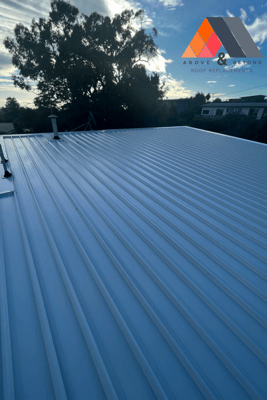 A White Metal Roof With A Tree In The Background – Melbourne, VIC - Above & Beyond Roof Replacements