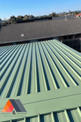 A Green Metal Roof With A Grove & Beyond Logo On It – Melbourne, VIC - Above & Beyond Roof Replacements